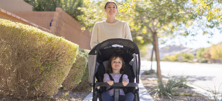 woman pushing baby in stroller